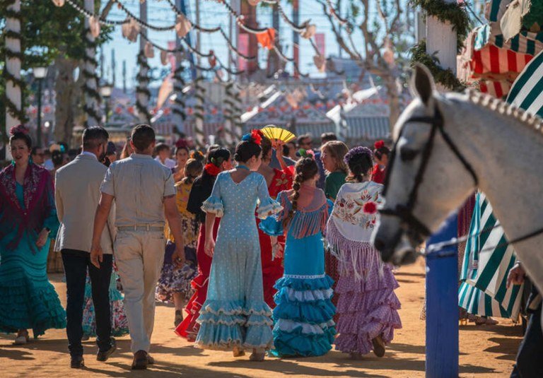 Feria de Abril in Sevilla, a group of people in colorful dresses and hats